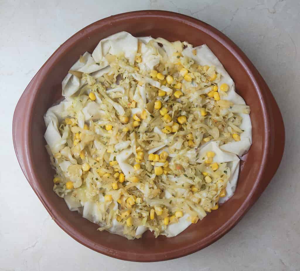 image showing how to top the phyllo dough sheet with cabbage and sweet corn